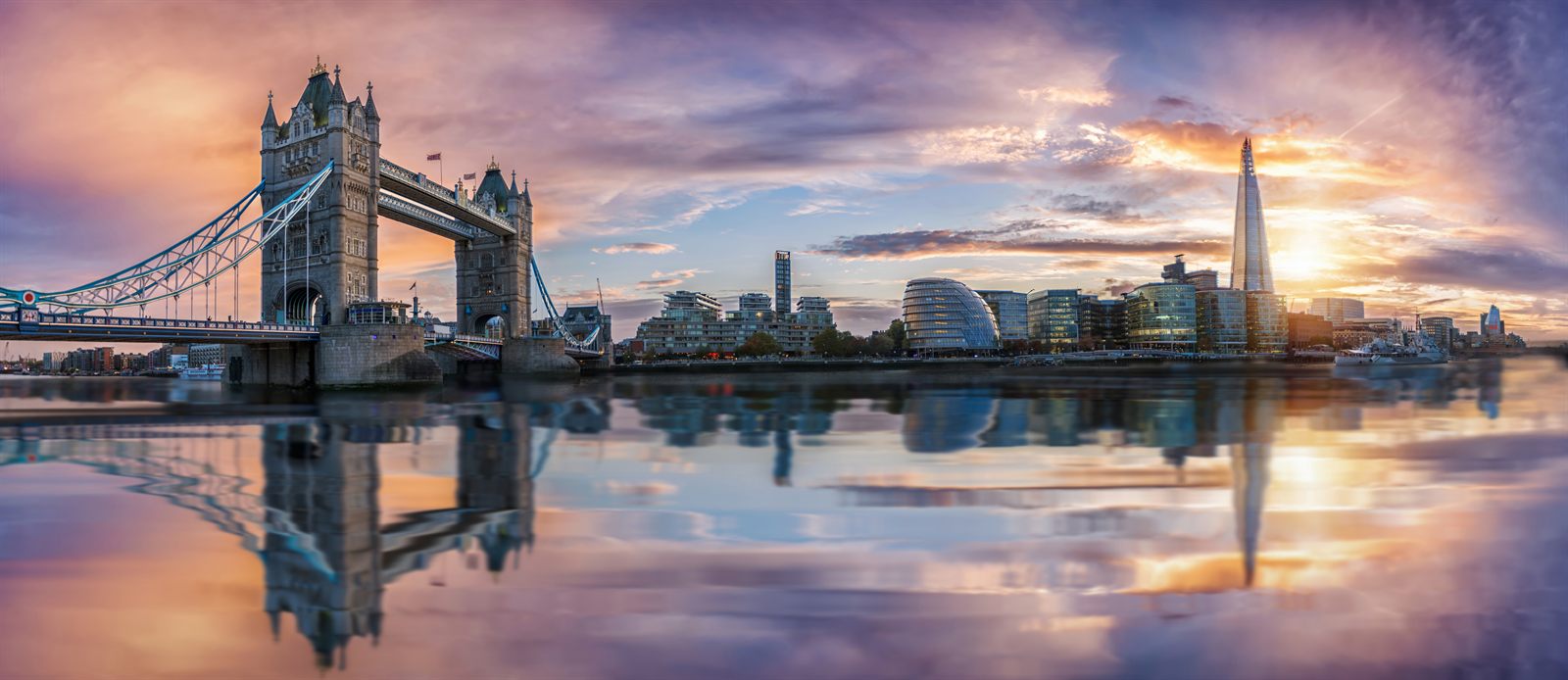 Tower Bridge and the London skyline reflected in the Thames at sunset