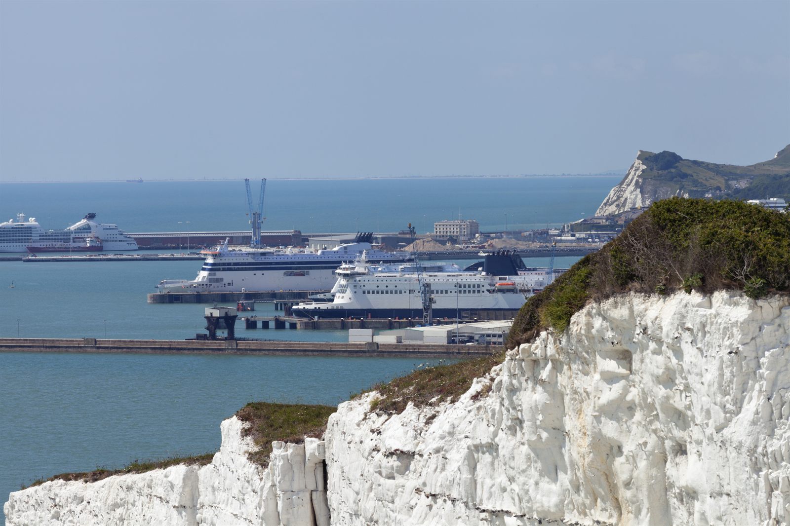 White chalk cliffs beside the busy harbor and cruise terminal at Dover