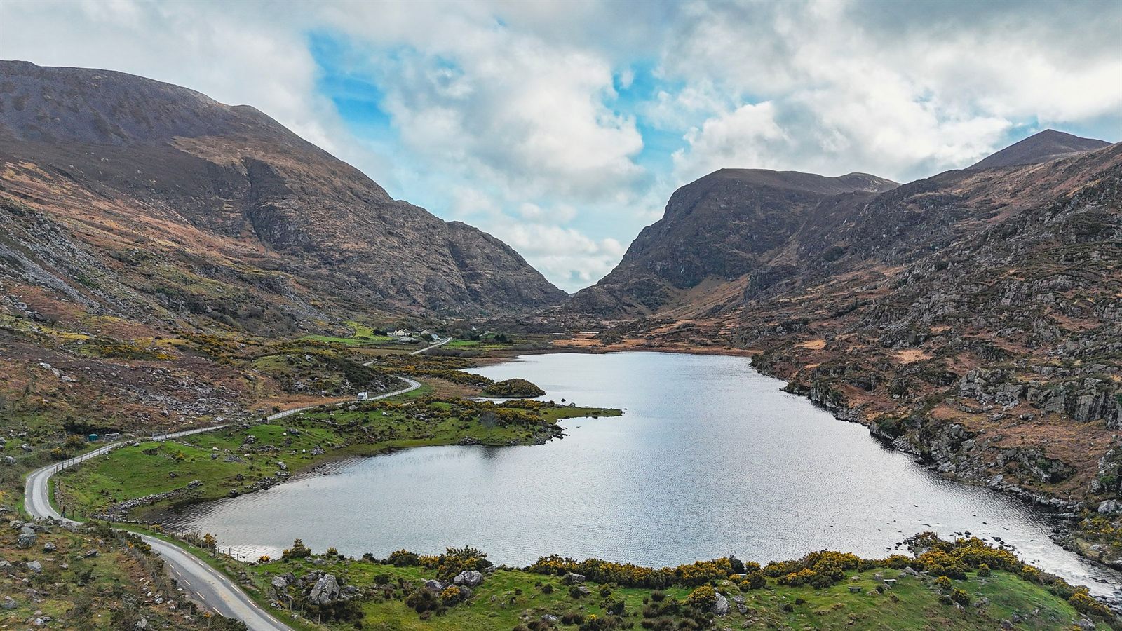 Lake winding through a green mountain valley in County Kerry